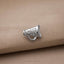 A silver cheerleader megaphone pin is displayed on a beige fabric surface.