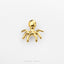 A small gold-colored octopus figurine is shown against a white background.