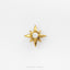 A gold star-shaped earring with a white gemstone in the center, set against a white background.