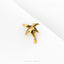 A small gold-colored earring in the shape of a palm tree is displayed against a white background.