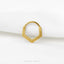 A gold-colored metal ring with a unique, textured design is displayed against a white background.