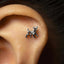 A small silver earring in the shape of a dog is visible in the person's ear.