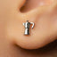 A small silver earring in the shape of a coffee cup is visible in the person's ear.