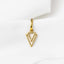 A gold-colored triangular pendant is hanging from a fabric surface.