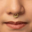 A close-up portrait of a young woman with a nose ring, looking directly at the camera with a neutral expression.