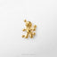 A small gold-colored figurine of a voodoo doll is shown against a white background.