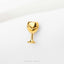 A small gold-colored wine glass-shaped pin or brooch is displayed against a white background.