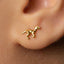 A close-up of a person's ear with a small gold-colored earring featuring a small animal design.