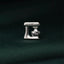 A silver-colored kitchen appliance, possibly a mixer or blender, is the central focus of the image, set against a dark green background.