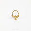 A gold-colored metal ring with a dragon design, featuring wings and a snake-like figure, is shown against a white background.