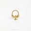 A gold-colored metal ring with a dragon design, featuring wings and a snake-like figure, is shown against a white background.